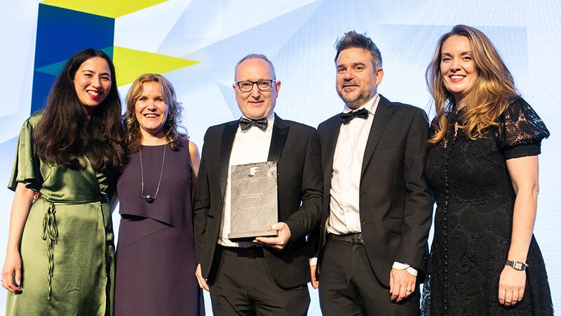 Cathal McGuinness, director, SAS International, presents the Fit Out Project of the Year award to DMVF Architects team.