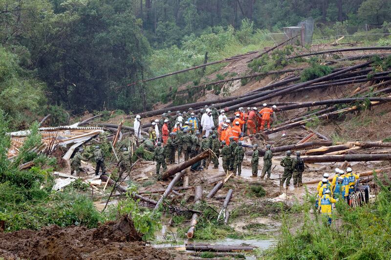 Rescuers conduct a search operation at the site of a landslide in Mimata, Miyazaki prefecture. Photograph: Kyodo News/AP