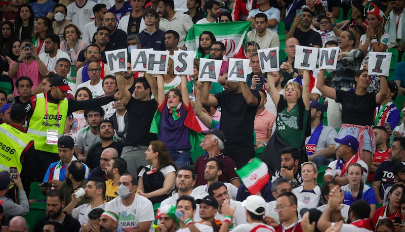 Iranian supporters hold letters forming the name Mahsa Amini as a government protest at a World Cup match between Iran and the US on November 29th. Photograph: Virginia Lefour/Belga Mag/AFP via Getty