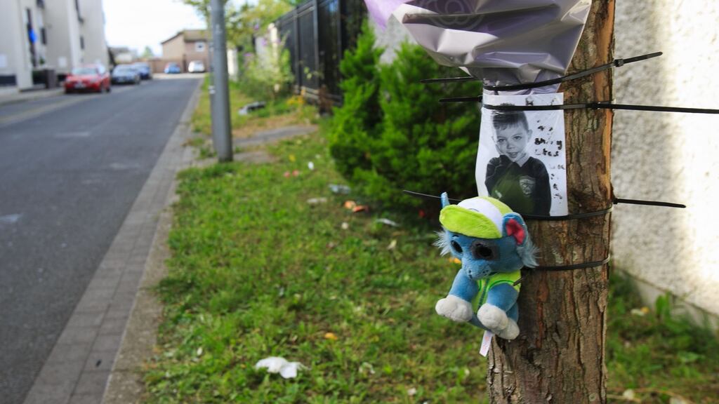 Flowers at the scene where a seven-year-old boy died after being struck by a road sweeper’s truck at St Joseph’s Way, Ballymun, Dublin. Photograph: Gareth Chaney/Collins