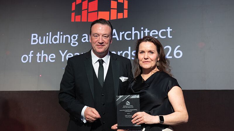 Mike Norton, MD, UK & Ireland at Swisspearl, presents the conservation award for a single building or development to Lisa McVeigh, DMVF Architects