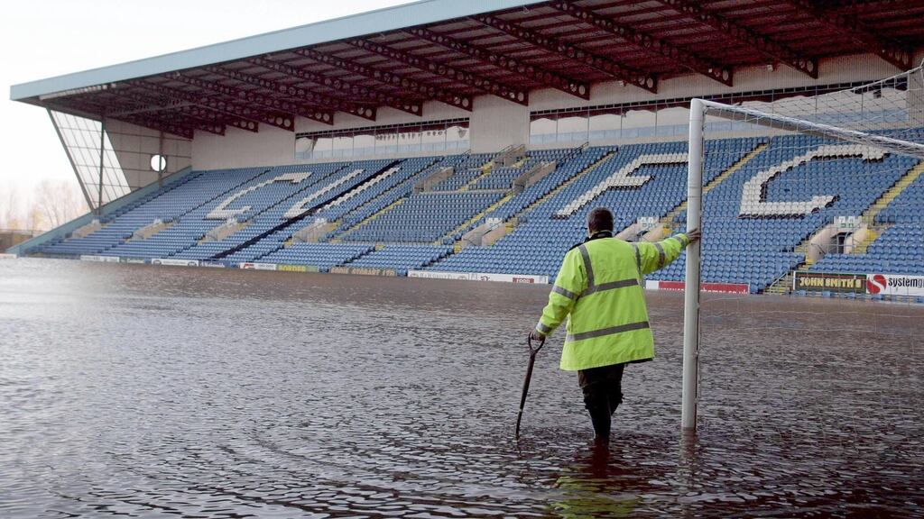 A groundsman looks out across Carlisle United’s flooded Brunton Park pitch earlier this month. The ground plays host to Everton in the FA Cup. Photograph: PA