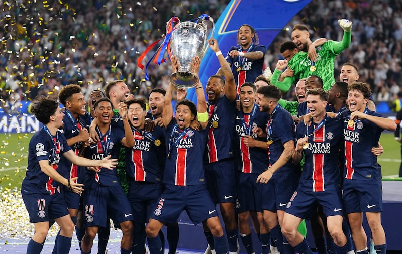 PSG captain Marquinhos raises the Champions League trophy after his side's 5-0 win over Inter Milan in Munich. Photograph: Mike Egerton/PA