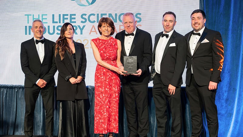 Tom O'Brien, business manager at Controlled Environments Company, presents the sustainability award to Astellas Dublin team