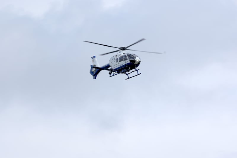The Garda helicopter flying over Casement Aerodrome on Sunday evening. Photograph: Colin Keegan/Collins Dublin