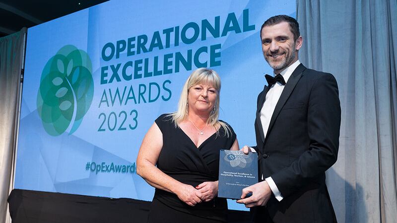 Sonia Fallon, bid manager and ESG lead at Sensori Facilities Management, presents the operational excellence in hospitality, tourism, and leisure award to Brian Lawlor, O'Donoghue Ring Collection