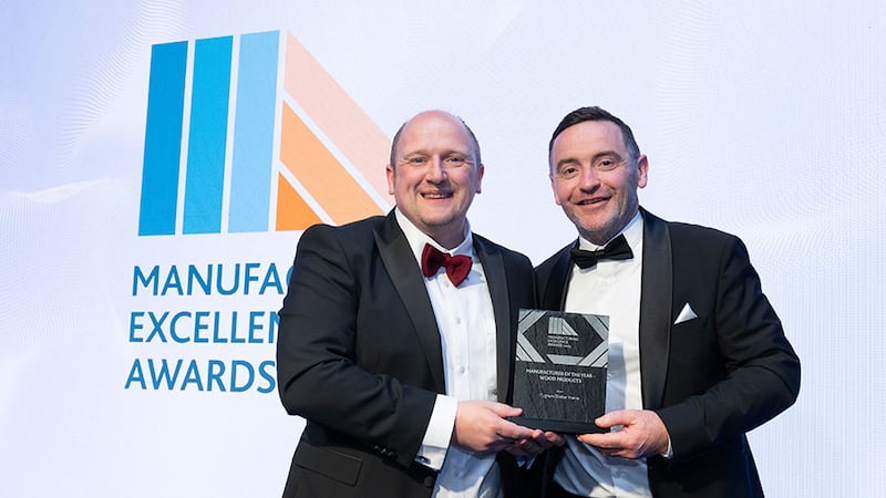 Dr Emmett Kerr, committee member at Irish Manufacturing Council, presents the manufacturer of the year - wood products award to Heber McMahon, Cygnum Timber Frame