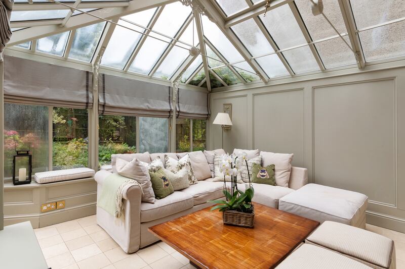 A sunroom with beautiful joinery, built-in seats and panelled walls leads from the breakfastroom to the garden.