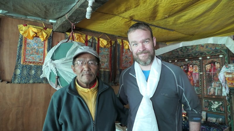 Rory McHugh at Pasang Nuru Sherpa’s house in Thametung. Pasang lost all his fingers and toes while pinned down by a storm in 1975 and has been painting ever since.
