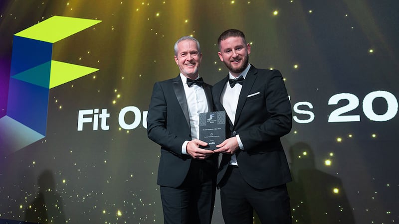 Gareth Lloyd, operations director at Walls Construction, presents the fit out product of the year award to Adam Kane, BusinessRiver on behalf of Synk