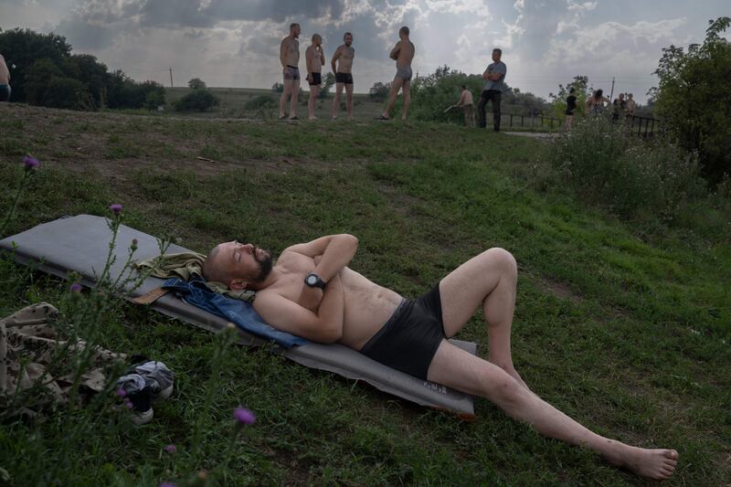Ukranian soldiers enjoy some rest and recreation a few kilometers away from the frontline in the Donbass region on August 11th, 2022. Photograph: Bulent Kilic/AFP/Getty