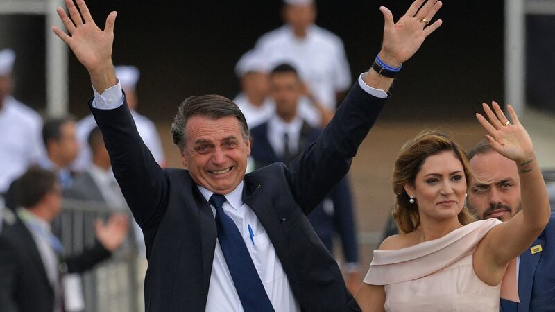 Brazil’s Jair Bolsonaro next to his wife Michelle Bolsonaro  in Brasilia in January. Photograph:  Carl de Souza/AFP via Getty Images