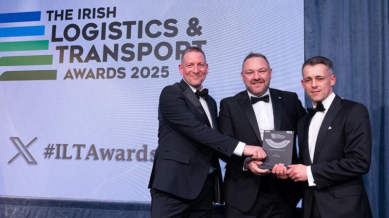 Gareth Dyer, finance & leasing at AIB, presents the green transformation award to Rainer Hoerbst and Keith Young, ATC Logistics.