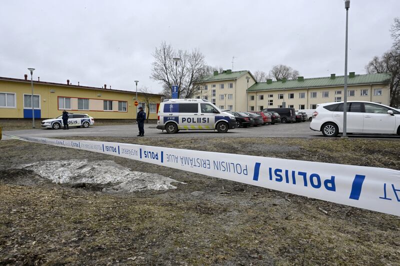 Finnish police officers guard the scene at the school where a child opened fire and injured three other children. Photograph: Markku Ulander/AFP