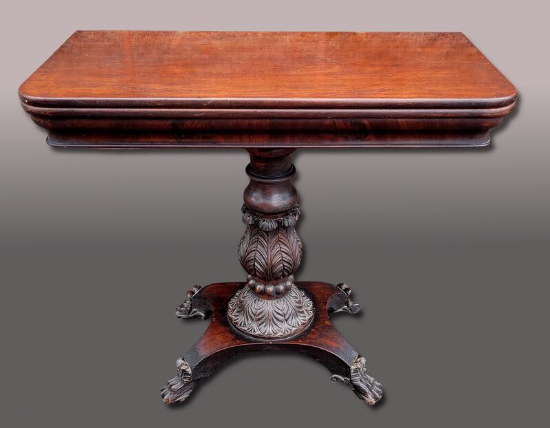 A 19th century mahogany fold over table with superb carved detail at the base, €800-€1,200 (Hegarty's).