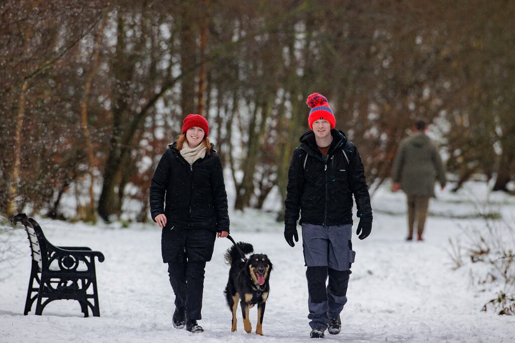 A couple walk their dog at Sixmilewater Park in Ballyclare, Co Antrim. Photograph: Liam McBurney/PA Wire