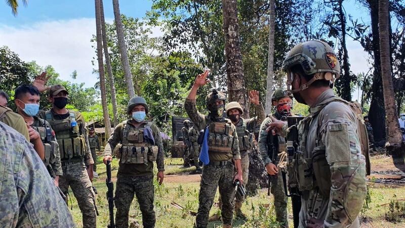 Filipino soldiers working on the crash site. Photograph: Joint Task Force Jolo-Armed Forces/EPA