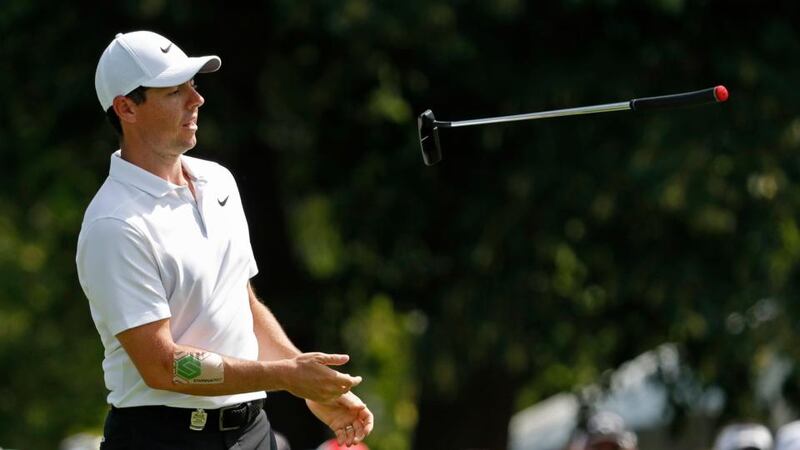 McIlroy, with some tape on his right arm, reacts to missing a putt on his 10th hole. Photo: Jeff Roberson/AP Photo