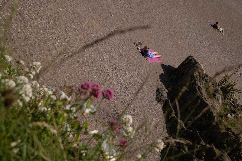 People take to sands with towels in Greystones. Photo: Natalia Campos