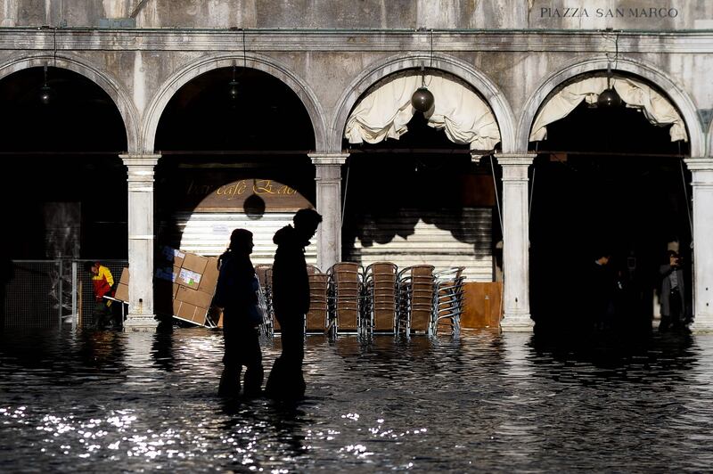 People walk across the flooded St Mark’s Square  in Venice on Thursday. Photograph:  Filippo Monteforte/AFP via Getty