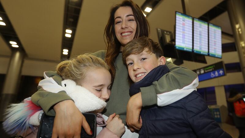 Sophia, Jack and Michael Gregg from Dublin welcome home their sister Louise Keogh from Canada. Photograph:  Lorraine O’Sullivan/The Irish Times