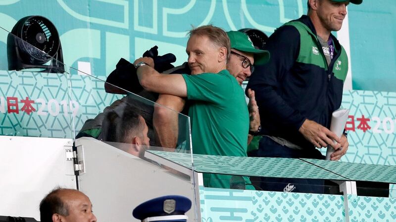 Joe Schmidt hugs  scrum coach Greg Feek after the defeat to New Zealand in Tokyo. Photograph: Dan Sheridan/Inpho