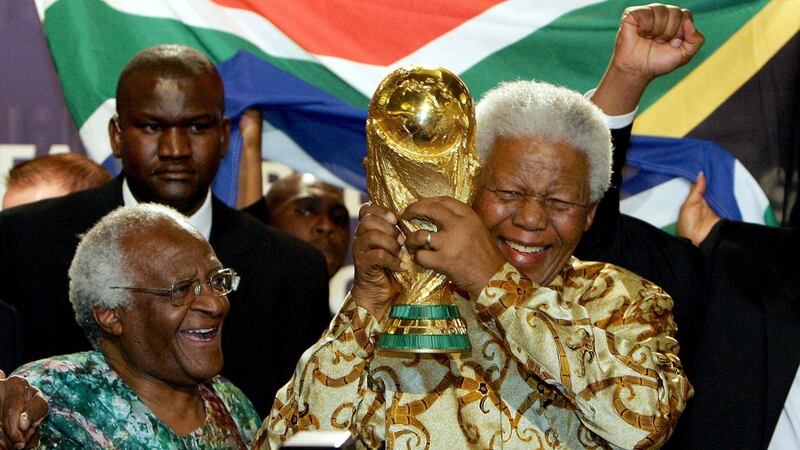 Nelson Mandela (R) holds the Jules Rimet World Cup beside  Archbishop Desmond Tutu. Photograph Franck Fife/AFP via Getty