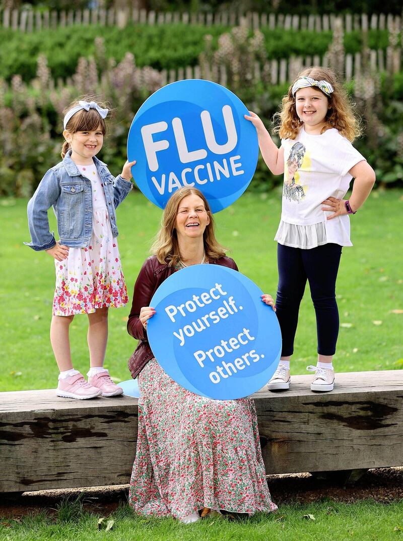 Megan Ayres (9) and Evelyn Ayres (6) from Co Meath, got their flu vaccines to protect themselves and their grandma, Geraldine Murtagh.  Photograph: Marc O’Sullivan