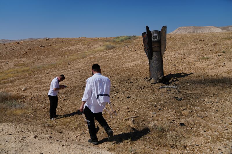 People take photos of the wreckage of an Iranian missile that landed near the West Bank city of Jericho. Photograph: Mahmoud Illean/AP