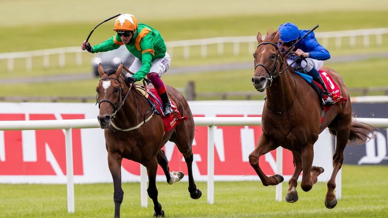 William Buick and  Hurricane Lane (blue) chase down  Frankie Dettori onboard Lone Eagle to win the Dubai Duty Free Irish Derby at the Curragh on Saturday. Photograph: Morgan Treacy/Inpho