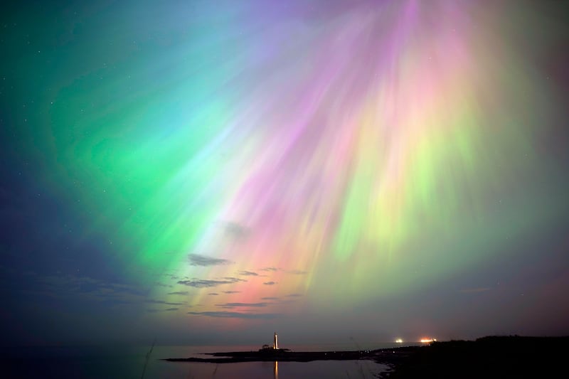The aurora borealis glow on the horizon at St Mary's Lighthouse in Whitley Bay on the northeast coast of Wales on Friday night. Photograph: Owen Humphreys/PA Wire