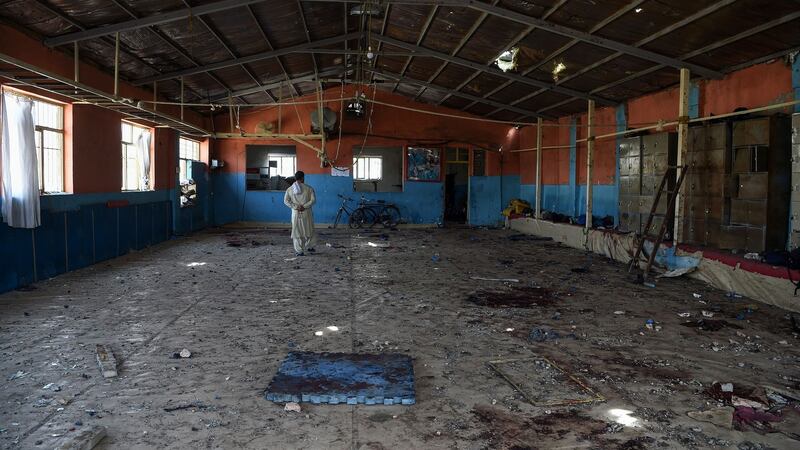 A  wrestler walks through Maiwand Wrestling Club after the suicide bombing. Photograph: Wakil Kohsar/AFP/Getty Images