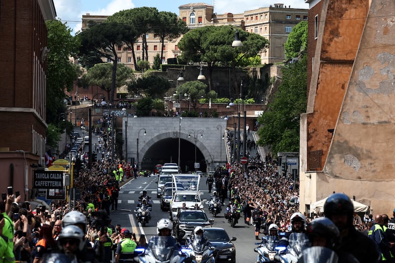 Well-wishers cheer as the coffin of late Pope Francis is transported on a popemobile from St Peter's Basilica to Santa Maria Maggiore Basilica, Photo by HENRY NICHOLLS/AFP
