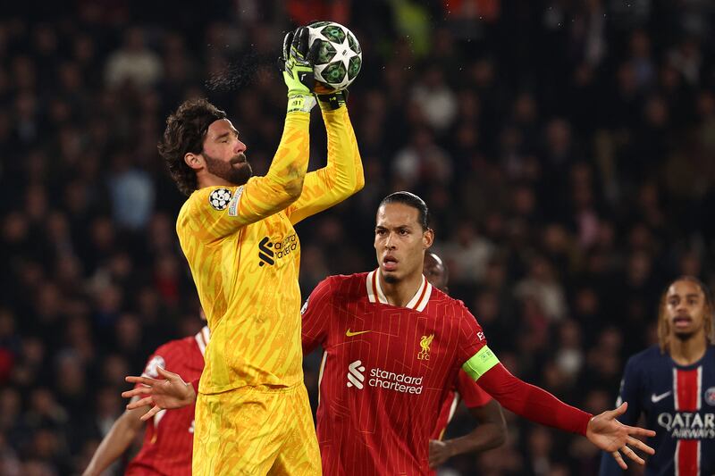 Liverpool's Brazilian goalkeeper Alisson catches the ball in front of Virgil van Dijk during the Champions League game in Paris. Photograph: Franck Fife/AFP via Getty