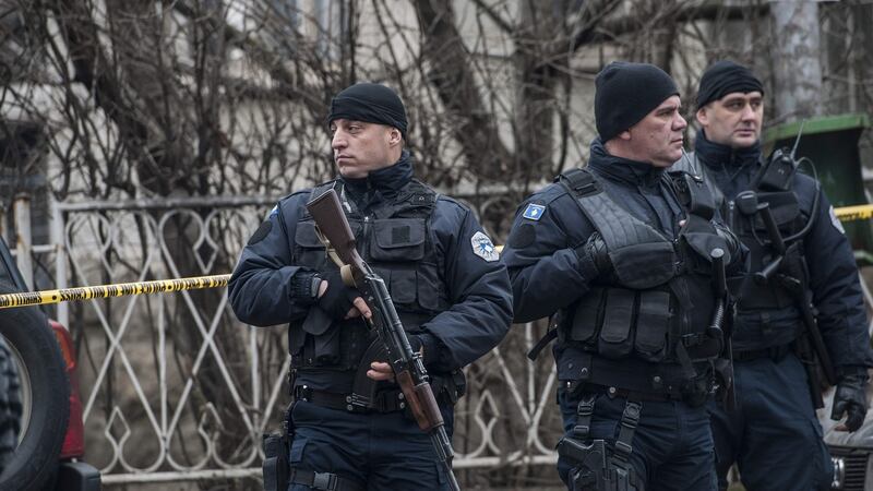 Kosovo police officers secure the area where Oliver Ivanovic was killed in Mitrovica on Tuesday. Photograph:  Armend Nimani/AFP/Getty Images