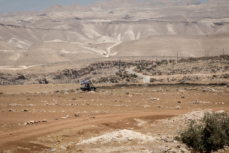 An all-terrain vehicle with an Israeli flag patrols on the outskirts of the Palestinian town of Tequ. Photograph: Sally Hayden
