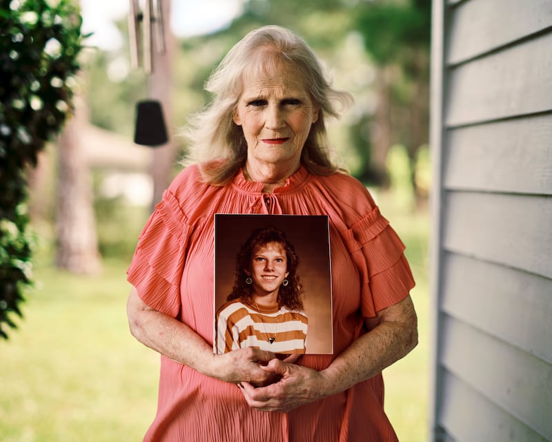 May Martinez holds a photo of her daughter, Colleen Slemmer, as she awaits the execution of her killer, Christa Pike. Photograph: Zack Wittman for The New York Times
                      