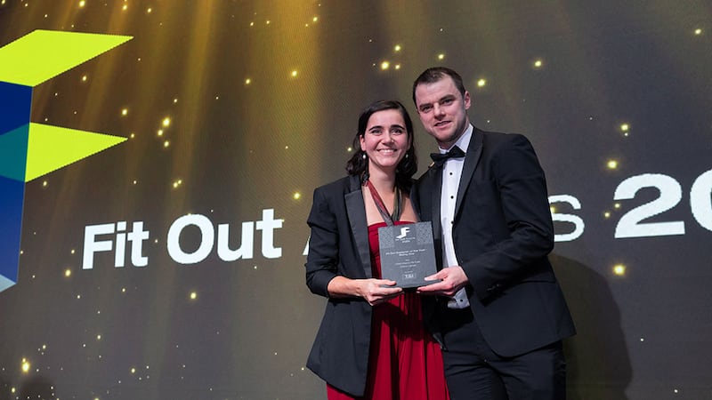 Noel Haverty, director at T&I Fit Outs, presents the fit out designer of the year - rising star award to Chloe Lasnet, CRM Interior Fit-Outs