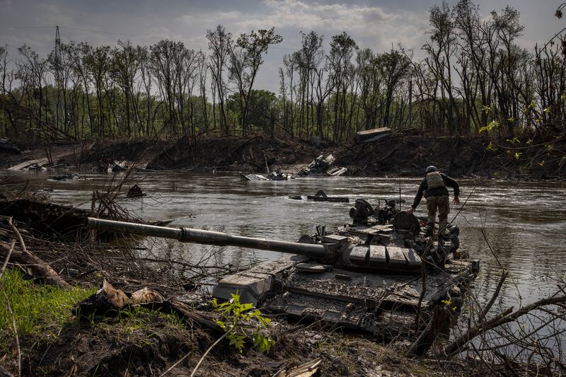 A Ukrainian soldier on an abandoned Russian tank in the Siversky Donets river, in Bilohorivka, Ukraine, in May. The river was also on the front line during the second World War. Photograph: Ivor Prickett/New York Times