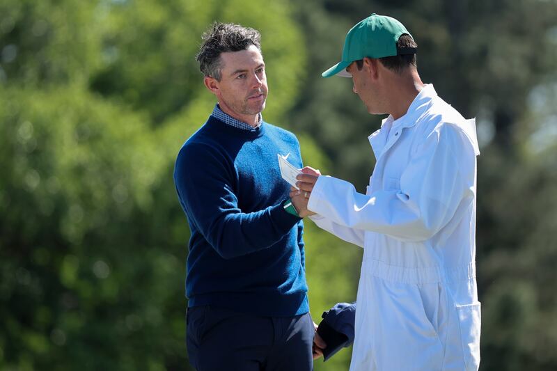 Rory McIlroy of Northern Ireland and his caddie Harry Diamond shake hands on the 18th green. Photograph: Hector Vivas/Getty