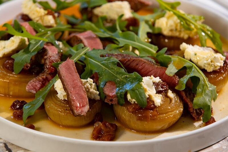 Slow-roasted onions with steak, Boursin and rocket