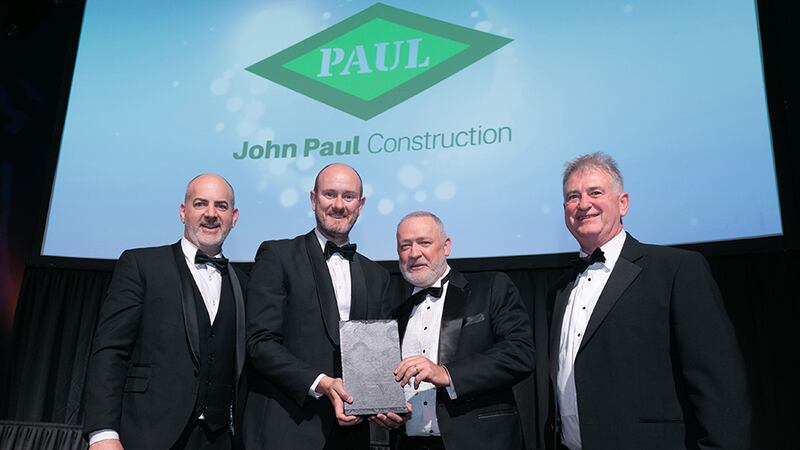 Alan Stewart, Head of Business Development & Marketing, HALT Natural Fire Retardant Treatment, presents the Construction Project of the Year award to John Paul Construction team.