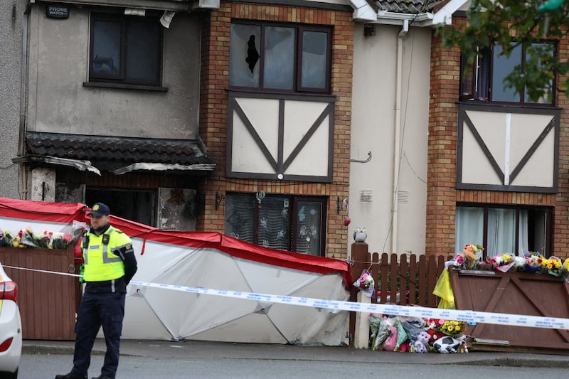 A garda at the house in which Philip and Kim English and their children Callum (12) and Jayden (nine) died in Tuesday's arson attack. Photograph: Stephen Collins/Collins Photos