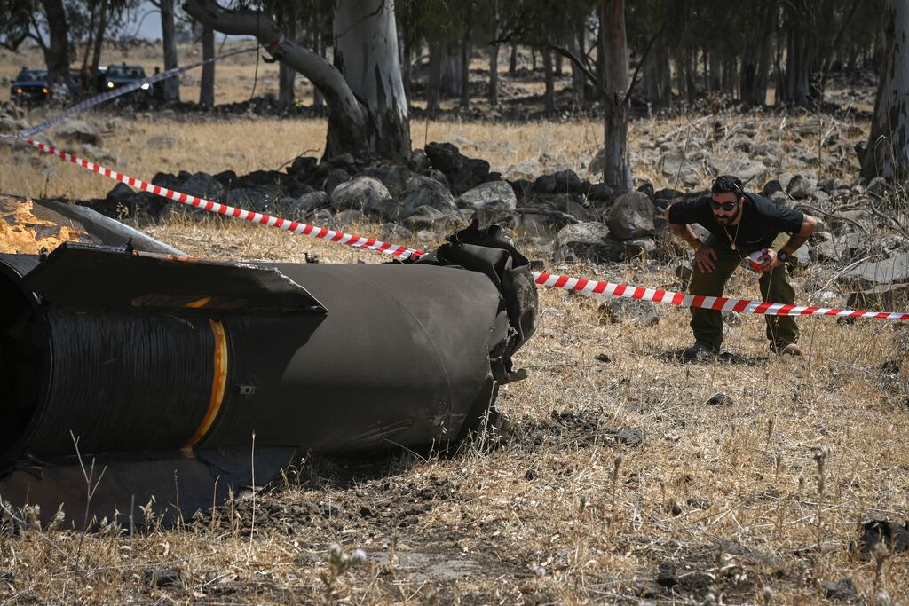 Members of the Israeli security forces check the apparent remains of an Iranian ballistic missile lying on the ground on the outskirts of Qatzrin in the Golan Heights on Monday. Photograph: Michael Giladi/Middle East Images/AFP via Getty Images