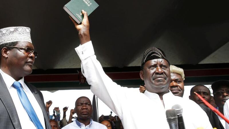 Kenyan opposition leader Raila Odinga holds a Bible as he takes a symbolic presidential oath of office in Nairobi on Tuesday. Photograph: Baz Ratner/Reuters
