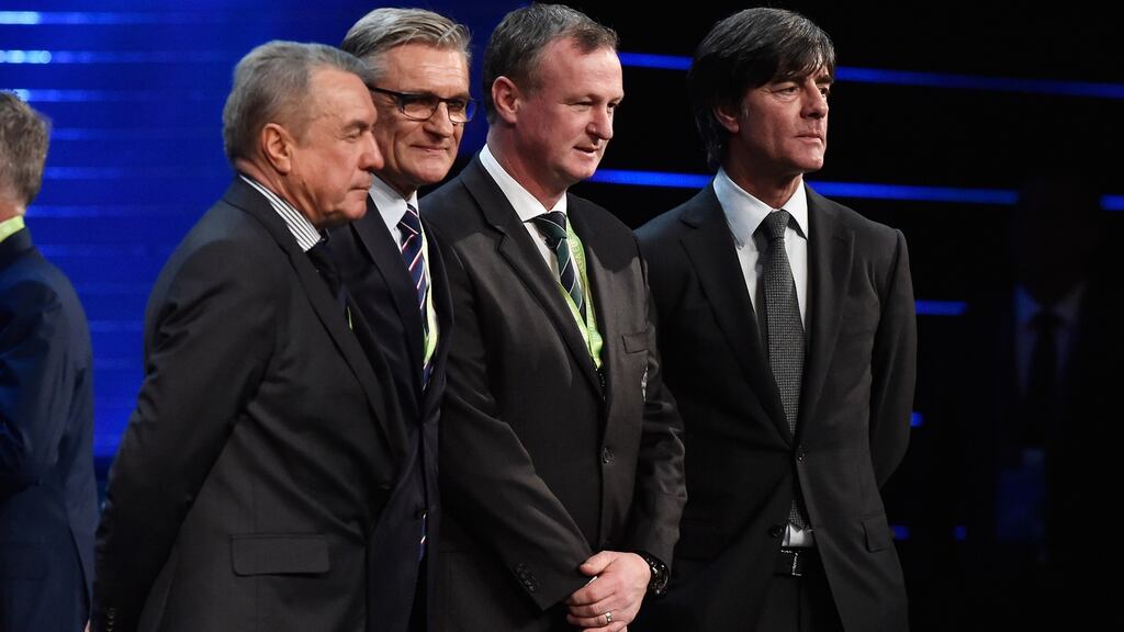 Ukraine assistant coach Volodymyr Onyshchenko, manager of Poland Adam Nawalka, Michael O’Neill and Germany boss Joachim Low pose after their sides were drawn together at next summer’s European Championships. Photograph: Getty
