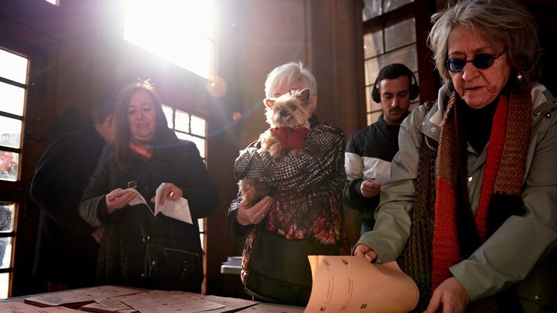 Spaniards take ballots for casting their vote in Barcelona. Photograph: Alex Caparros/Getty