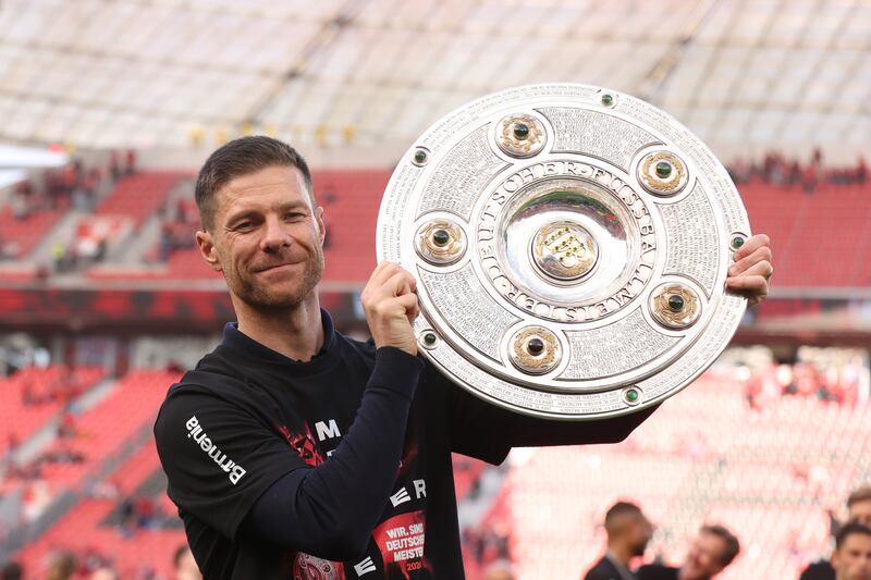 Xabi Alonso celebrates with the Bundesliga trophy after his Bayer Leverkusen's side remarkable season. Photograph: Alex Grimm/Getty Images