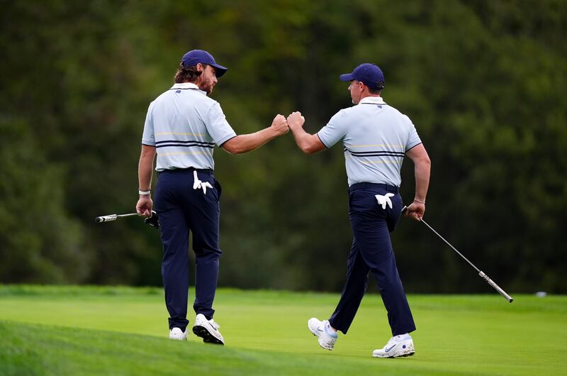 Tommy Fleetwood and Rory McIlroy fist bump during their foursomes win at Bethpage Black. Photograph: Mike Egerton/PA Wire