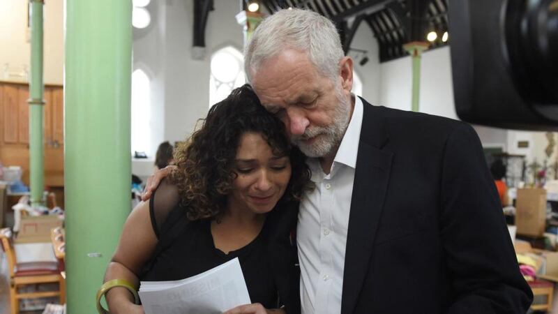 British Labour leader Jeremy Corbyn comforts a local resident  at St Clement’s Church in west London where volunteers have provided shelter and support for people affected by the fire at Grenfell Tower. Photograph: David Mirzoeff/PA Wire